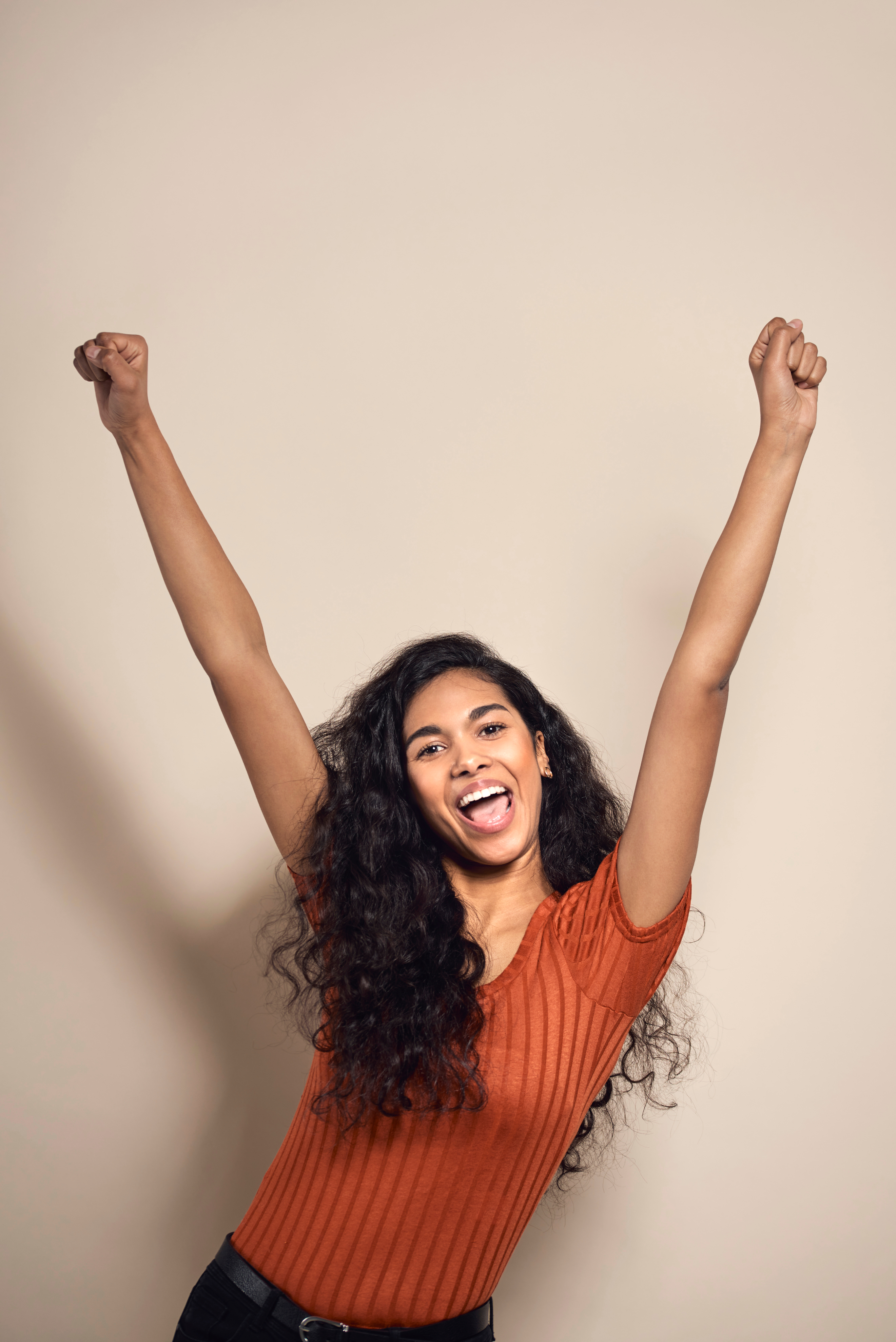 Woman with arms up, embracing freedom