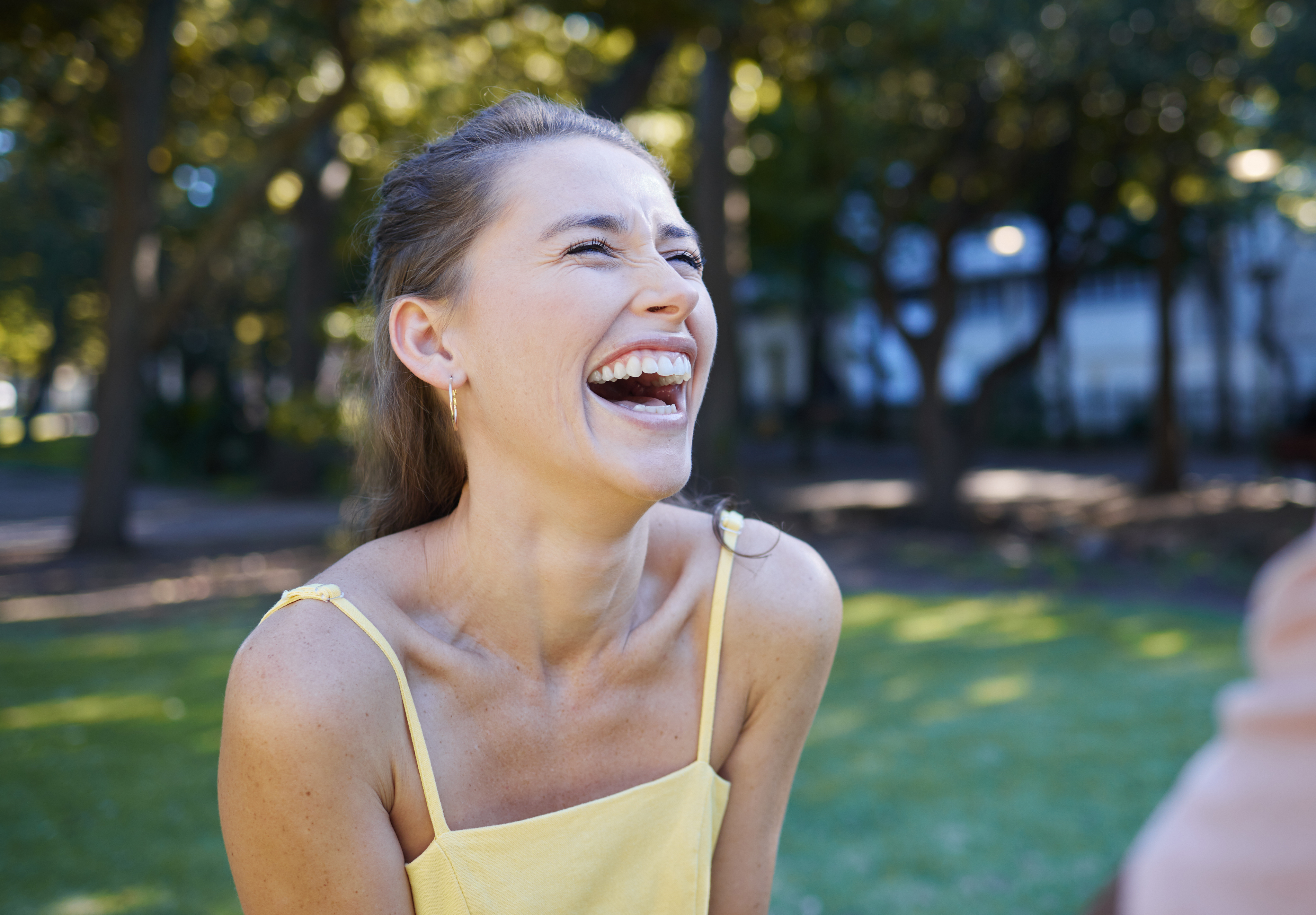Woman laughing freely outdoors